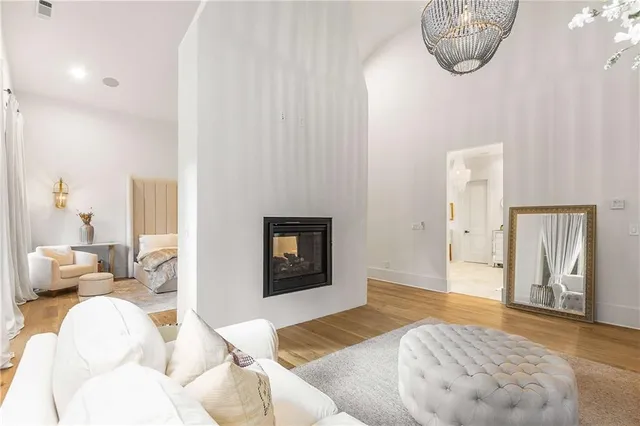 a bathroom with a toilet a sink a mirror and shower