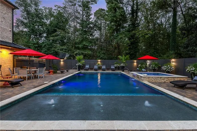 an outdoor space with swimming pool and furniture