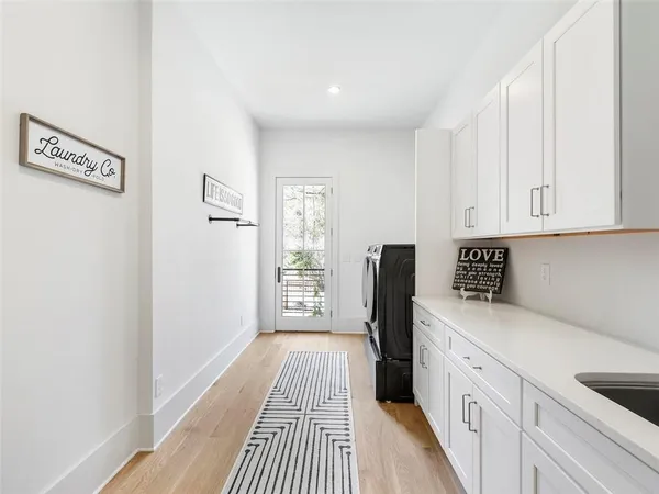 an aerial view of residential houses with outdoor space and trees