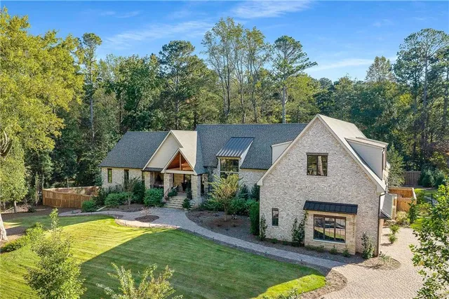 a front view of a house with a yard and a garage