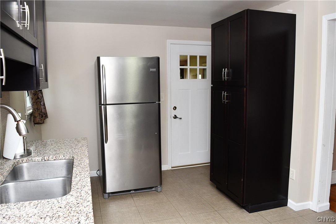 6 Triangle Place Lysander, NY 13027 - Photo 24 of 47 The back door next to refrigerator leads you to th