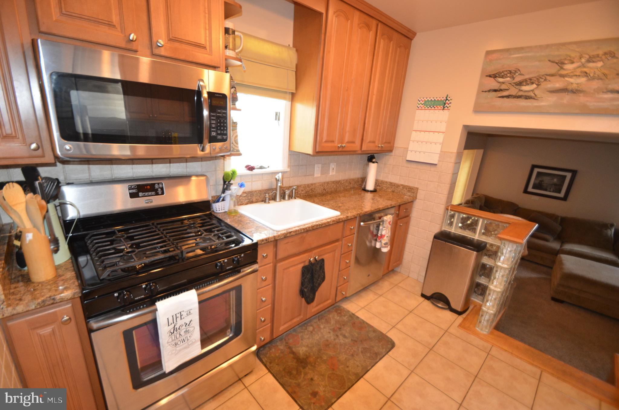 422 Madingley Road Linthicum Heights, MD 21090 - Photo 11 of 36 a kitchen with stainless steel appliances a stove microwave and sink
