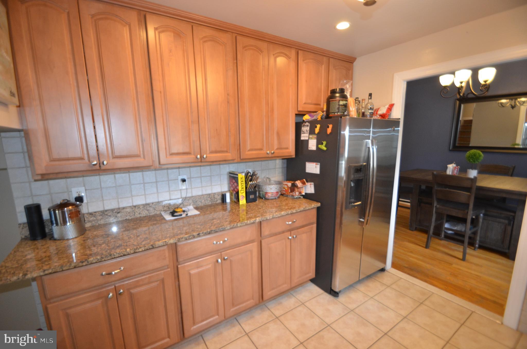 422 Madingley Road Linthicum Heights, MD 21090 - Photo 14 of 36 a kitchen with stainless steel appliances granite countertop a refrigerator and cabinets