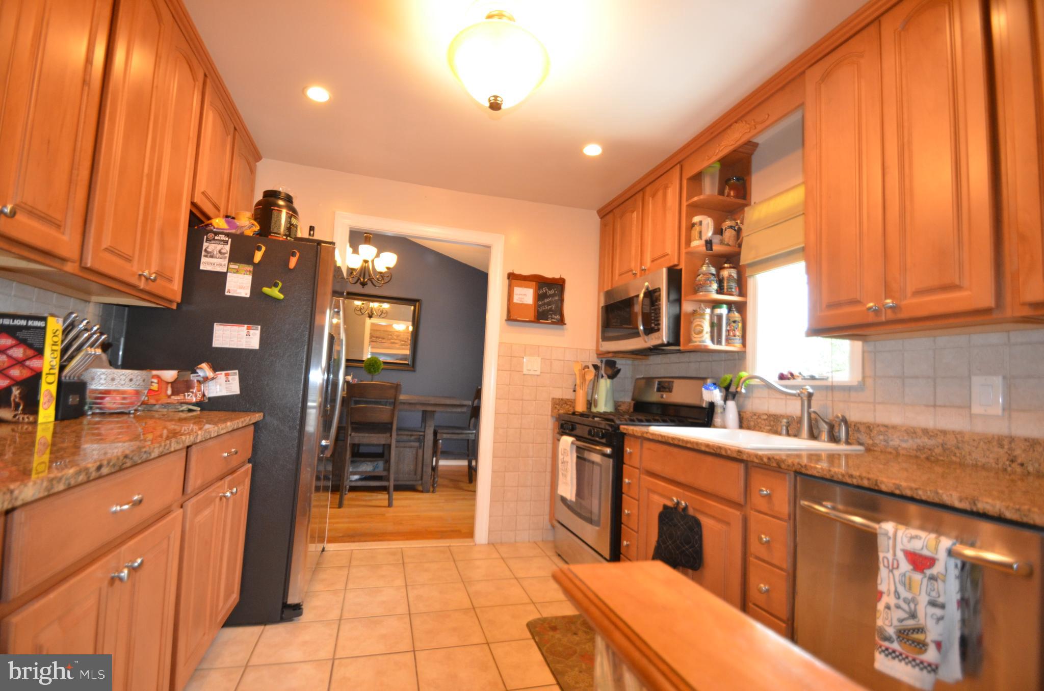 422 Madingley Road Linthicum Heights, MD 21090 - Photo 15 of 36 a kitchen with stainless steel appliances granite countertop a sink and cabinets