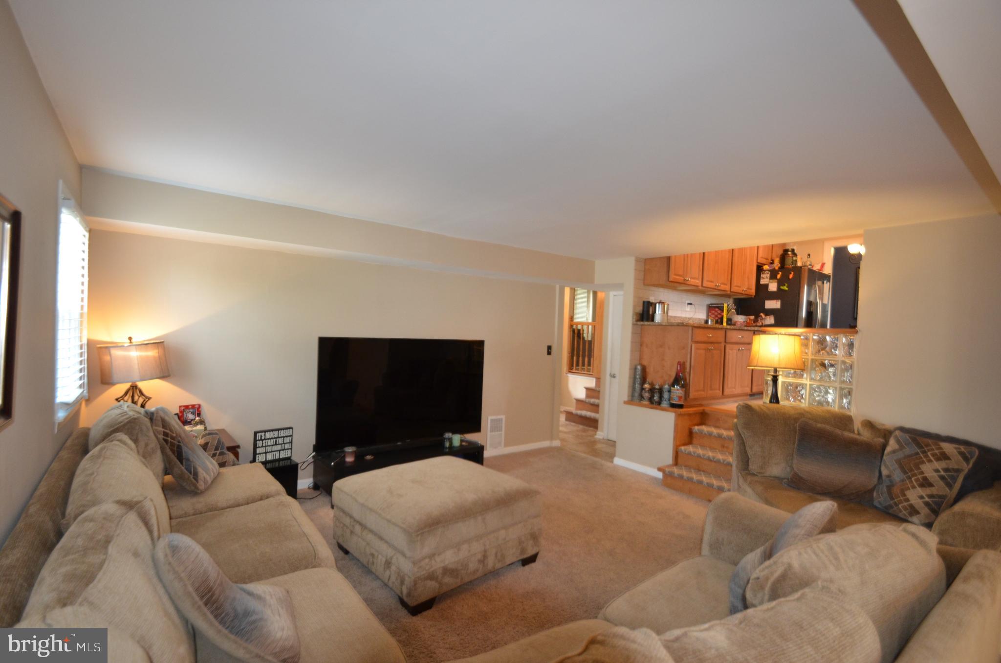 422 Madingley Road Linthicum Heights, MD 21090 - Photo 16 of 36 a living room with furniture and a flat screen tv