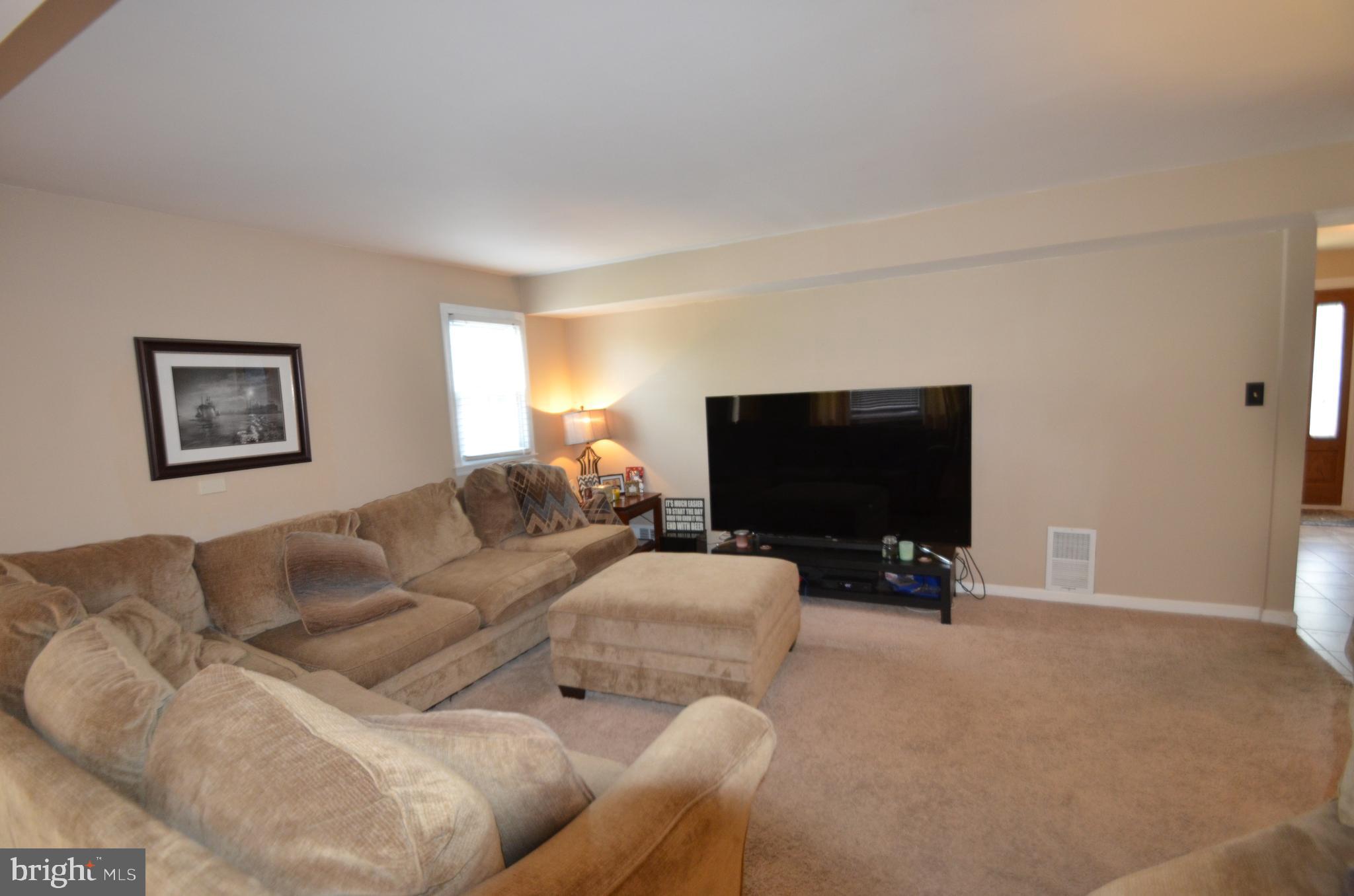 422 Madingley Road Linthicum Heights, MD 21090 - Photo 17 of 36 a living room with furniture and a flat screen tv