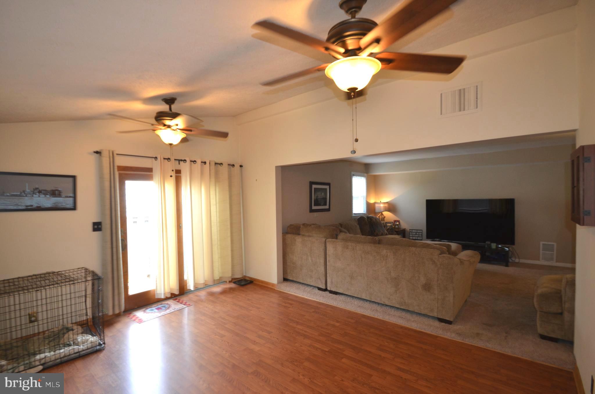 422 Madingley Road Linthicum Heights, MD 21090 - Photo 20 of 36 a view of a livingroom with furniture chandelier fan and a fireplace