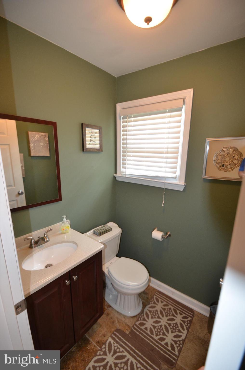422 Madingley Road Linthicum Heights, MD 21090 - Photo 21 of 36 a bathroom with a sink a toilet and a mirror