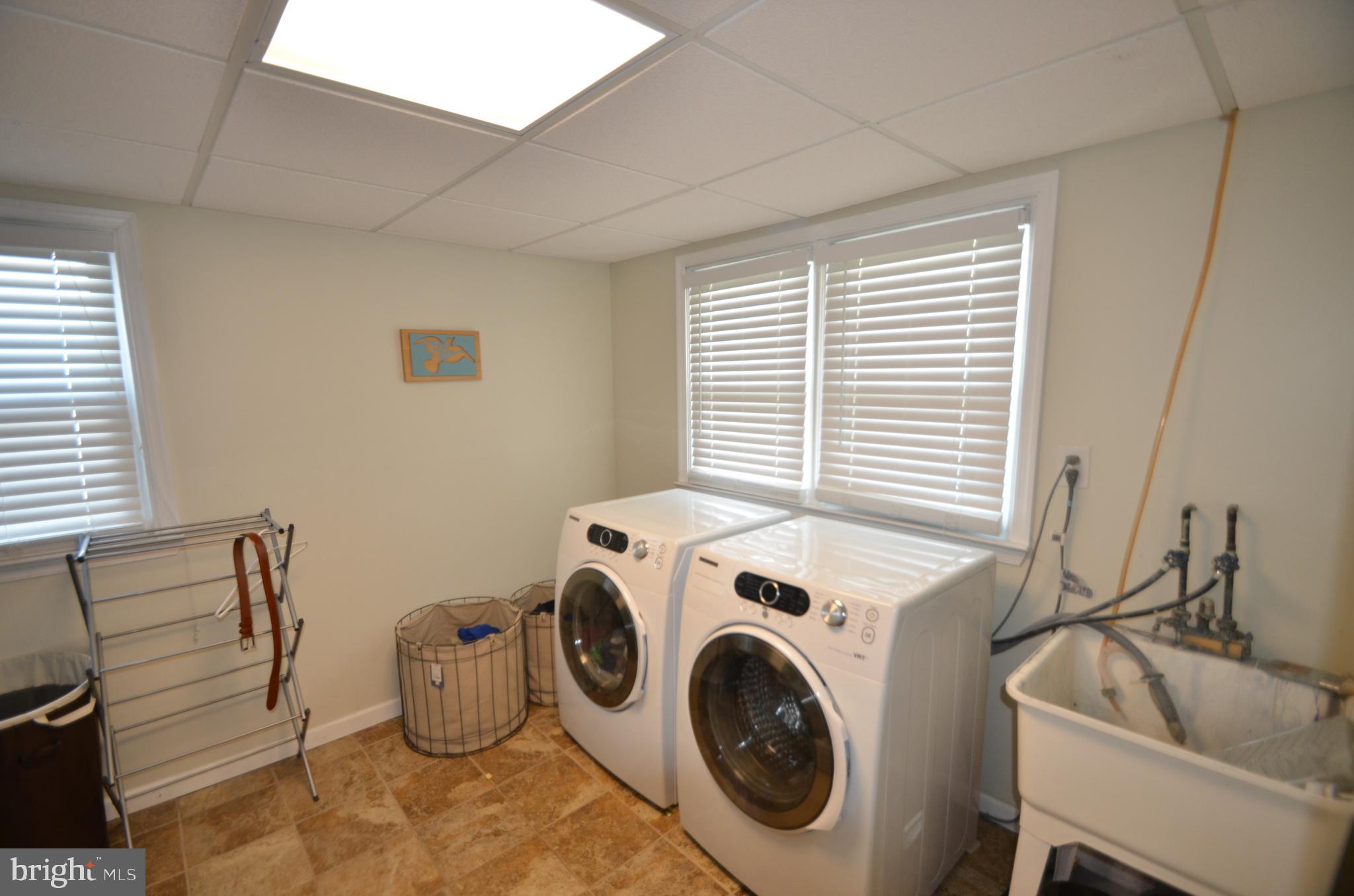 422 Madingley Road Linthicum Heights, MD 21090 - Photo 22 of 36 a view of washer and dryer with kitchen in the background