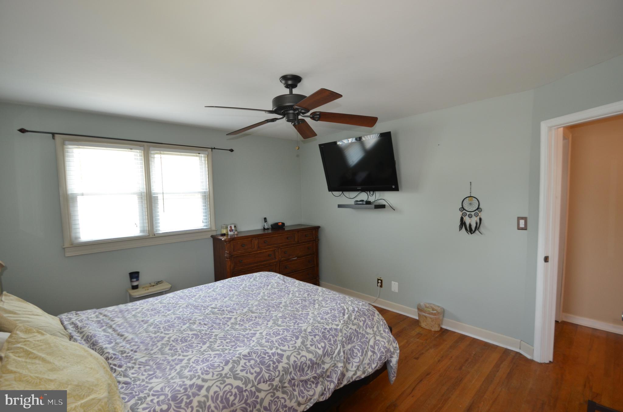 422 Madingley Road Linthicum Heights, MD 21090 - Photo 24 of 36 a bedroom with a bed and a flat screen tv
