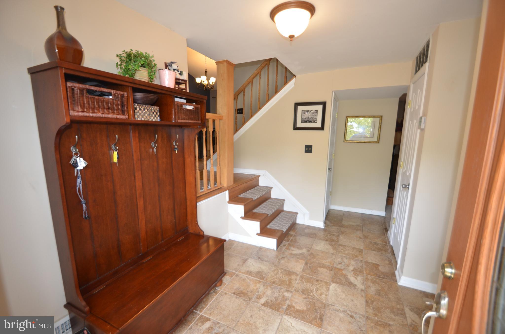 422 Madingley Road Linthicum Heights, MD 21090 - Photo 4 of 36 a view of a hallway with entryway wooden floor and windows