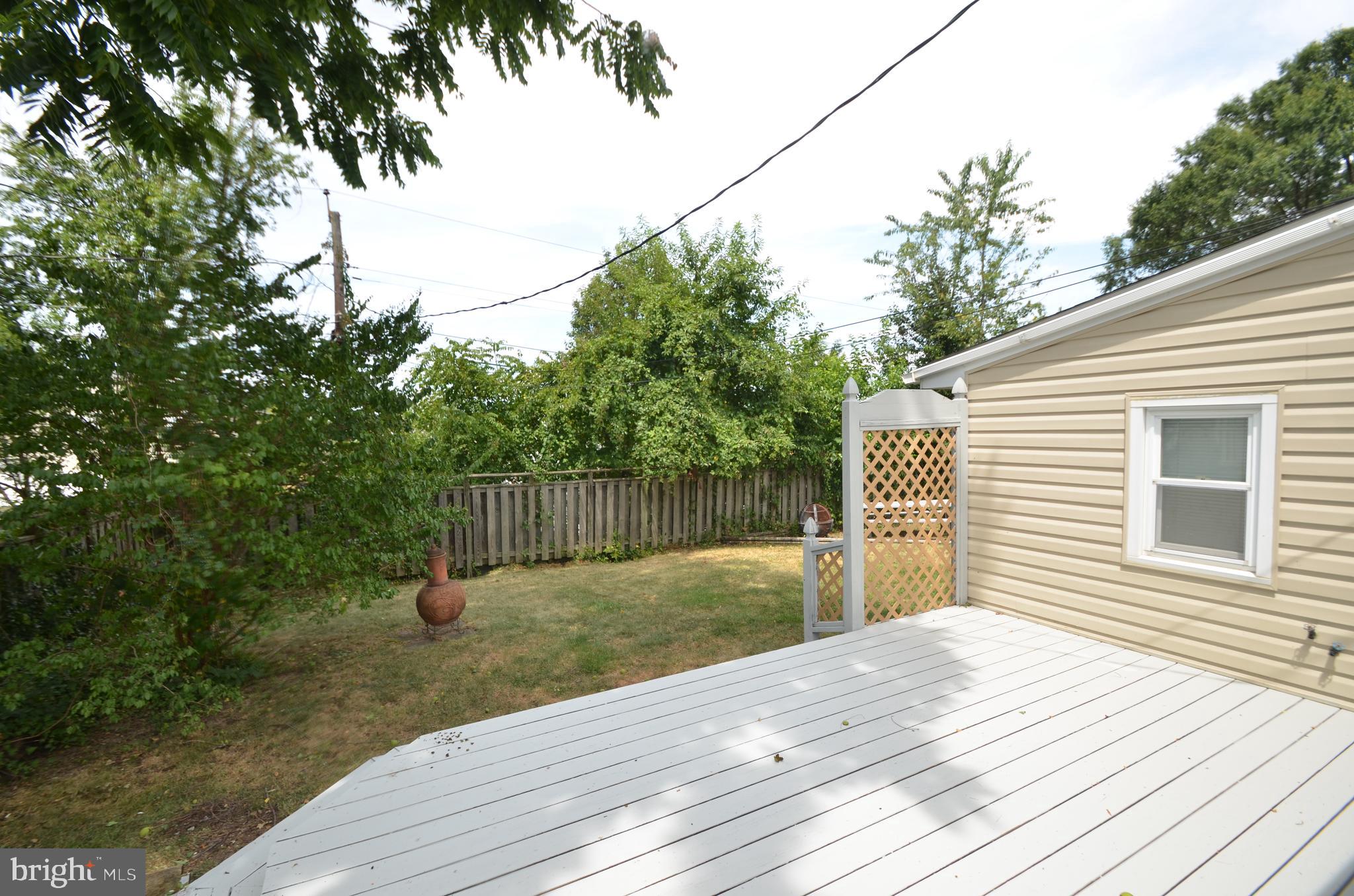 422 Madingley Road Linthicum Heights, MD 21090 - Photo 33 of 36 a backyard of a house with potted plants and large trees