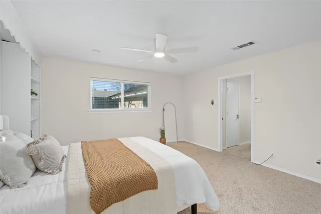 a bedroom with a large bed and a window