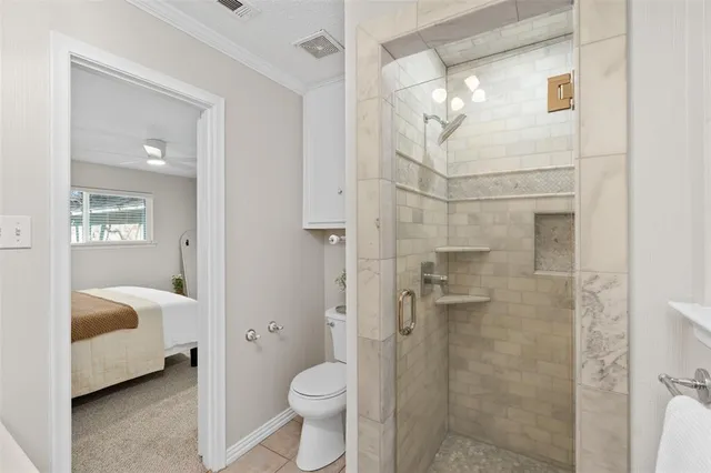a bathroom with a toilet a sink and shower