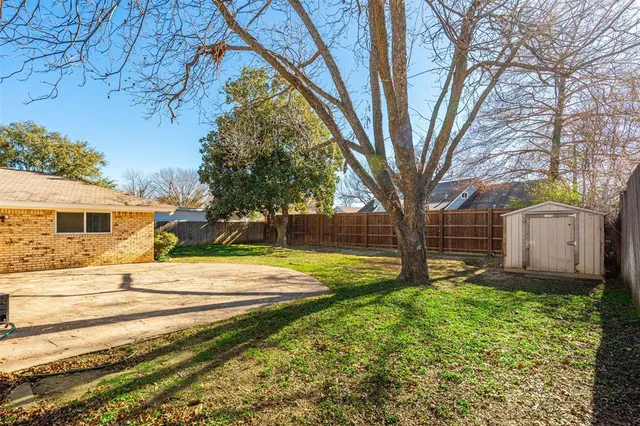 a front view of a house with yard and green space