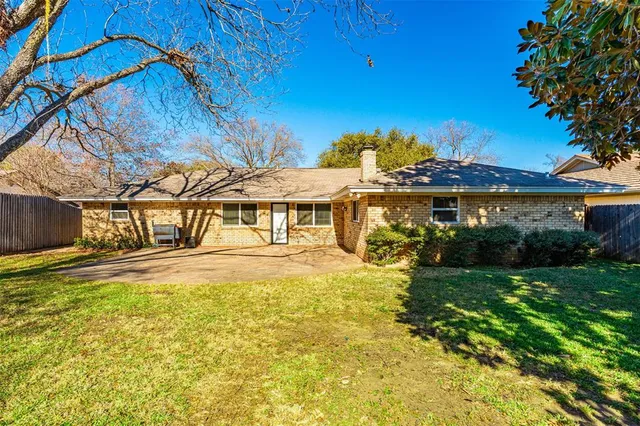 a view of yard with swimming pool and wooden fence