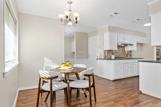 a view of a dining room with furniture and wooden floor
