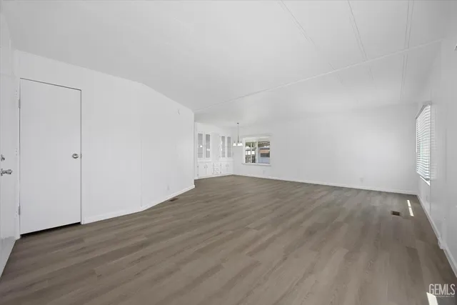 an empty room with wooden floor