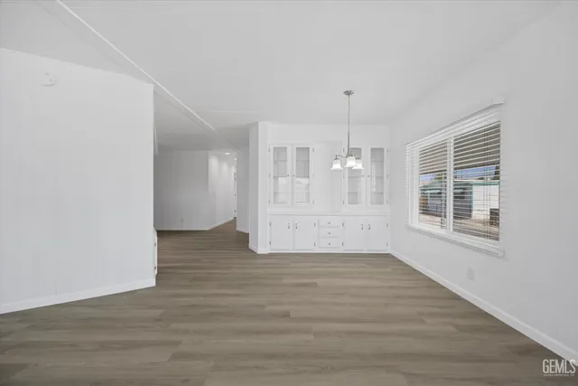 a view of a kitchen with wooden floor and a window