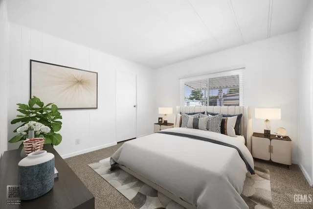 a bedroom with a bed and a potted plant