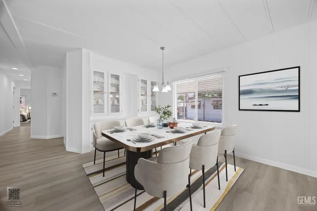 a dining room with furniture a chandelier and wooden floor