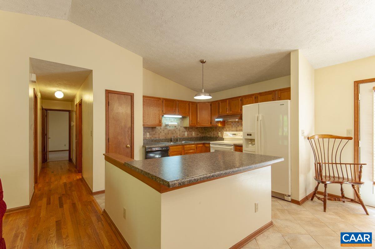 177 Happy Hollow Road Ruckersville, VA 22968 - Photo 8 of 37 a kitchen with stainless steel appliances granite countertop a refrigerator a sink and a stove