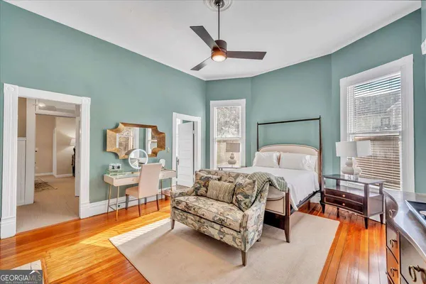 a bedroom with a bed couch and a window