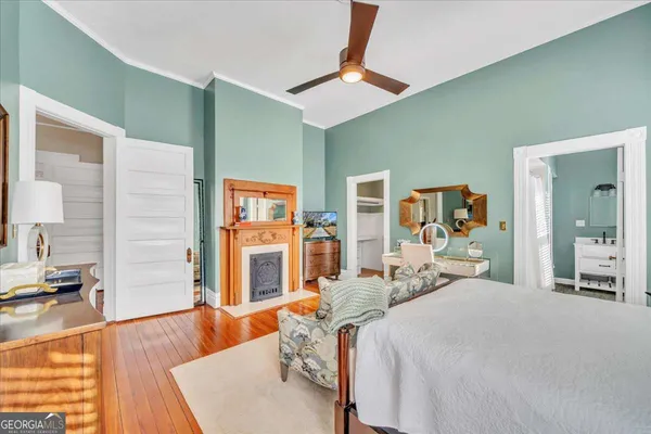 a living room with furniture and a painting on the wall