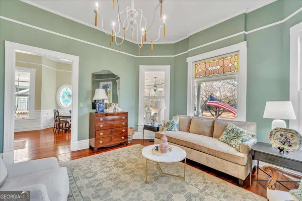a view of a dining room with furniture and a chandelier
