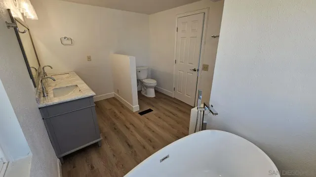 a bathroom with a sink a toilet and a mirror