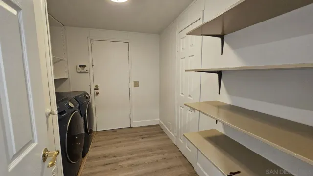 a view of a storage and utility room with washer and dryer