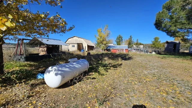 a view of a house with a yard and sitting area