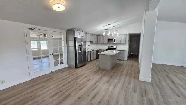 a view of a kitchen with furniture and wooden floor