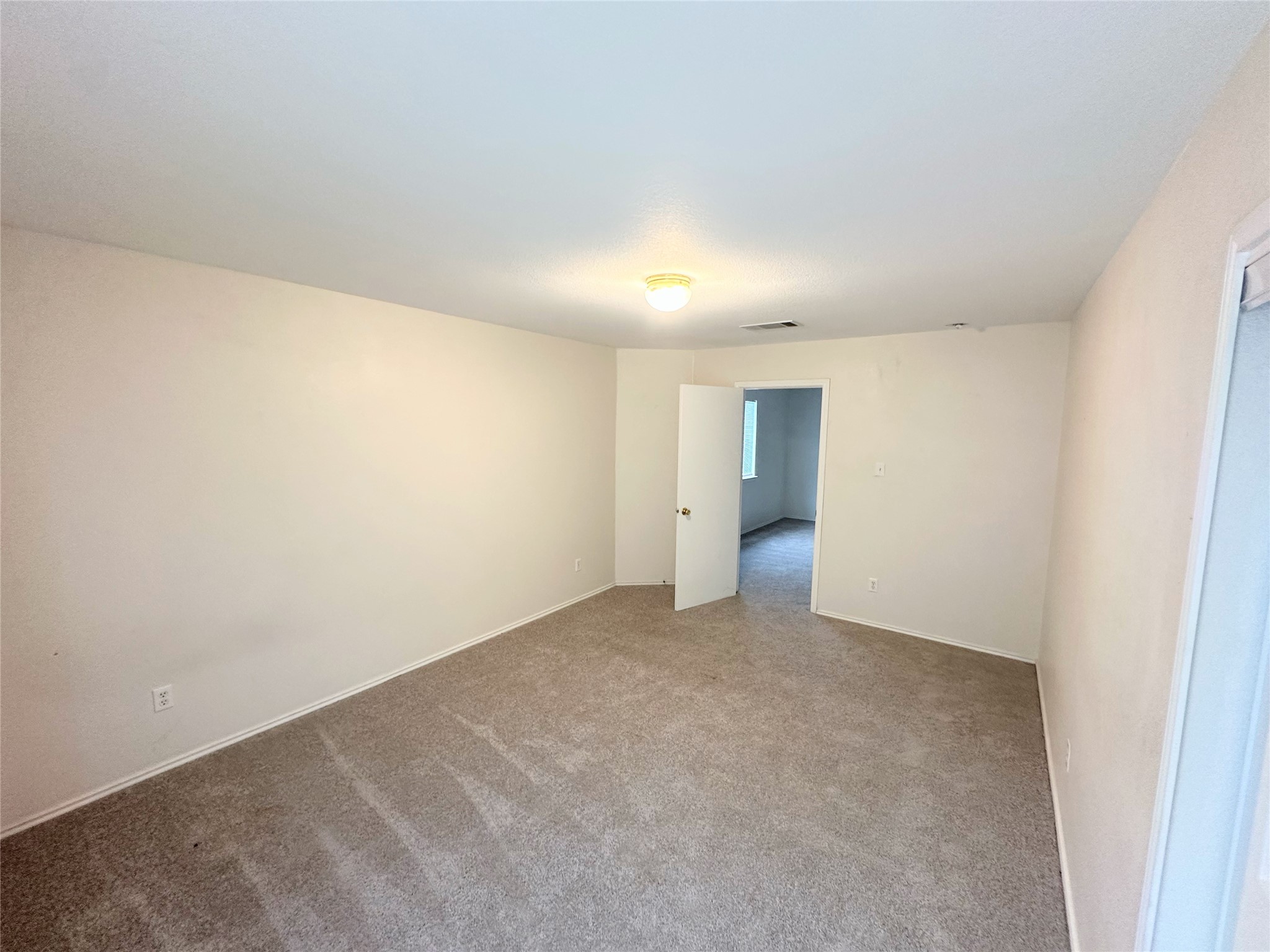 12929 Waynespur Lane Elgin, TX 78621 - Photo 13 of 20 The property features a room with light-colored walls and patterned carpet flooring