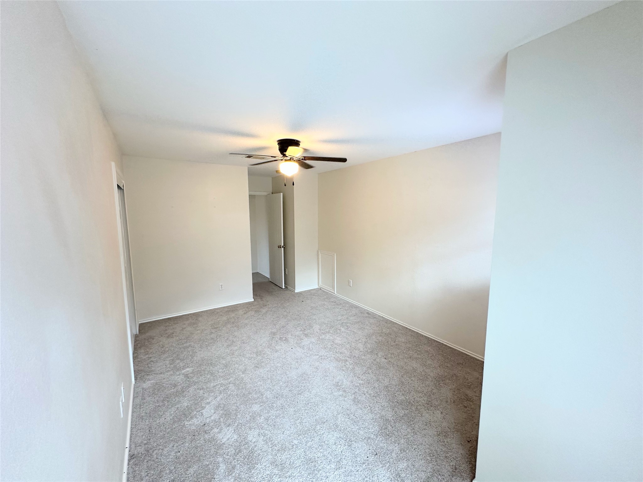 12929 Waynespur Lane Elgin, TX 78621 - Photo 17 of 20 Spacious room featuring carpeted flooring, light-colored walls, and a ceiling fan with integrated lighting
