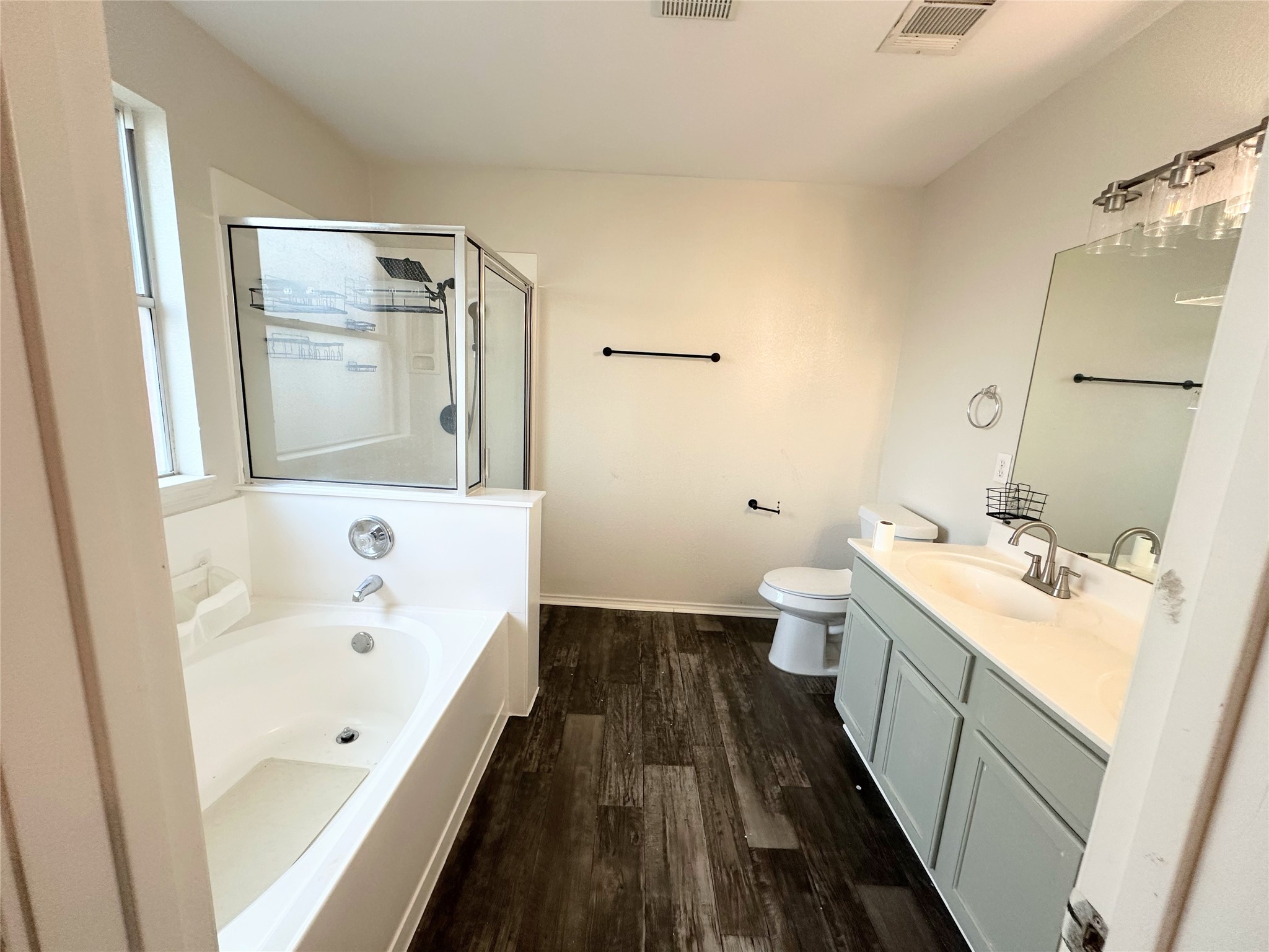 12929 Waynespur Lane Elgin, TX 78621 - Photo 9 of 20 Bathroom with a garden tub, an enclosed shower, a window, and double vanity