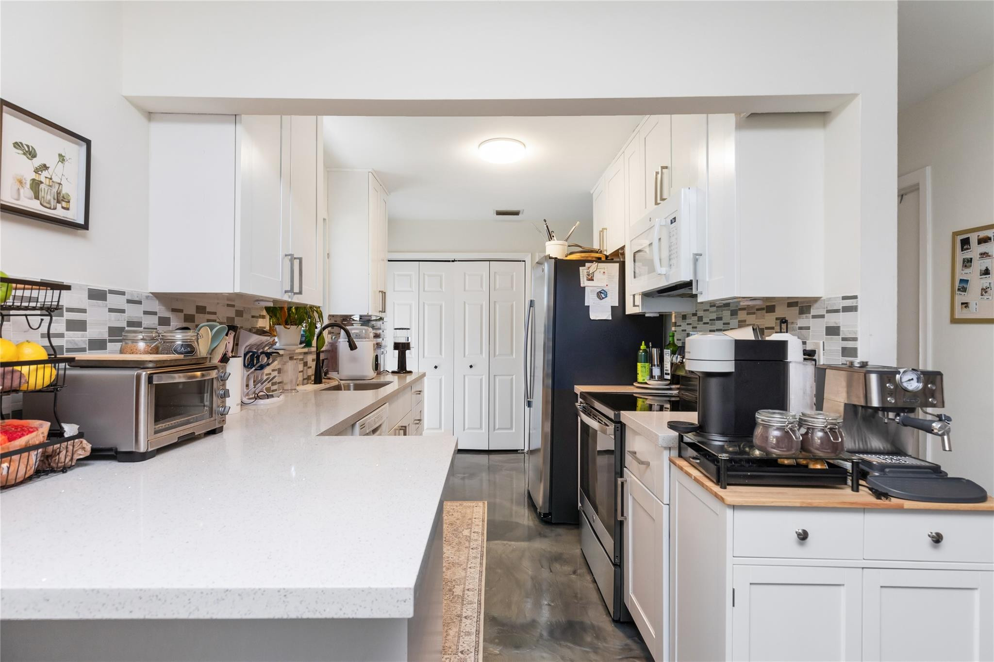 3461 Southwest 24th Street Miami, FL 33145 - Photo 13 of 55 a kitchen with stainless steel appliances a stove a sink and a refrigerator