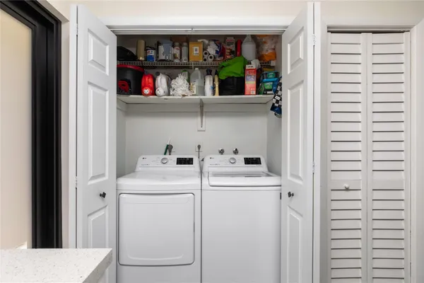 a bedroom with a bed and a flat tv screen on dresser