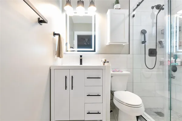 a bathroom with a sink toilet and shower