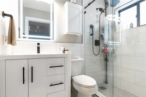 a bathroom with a sink a toilet and a shower curtain