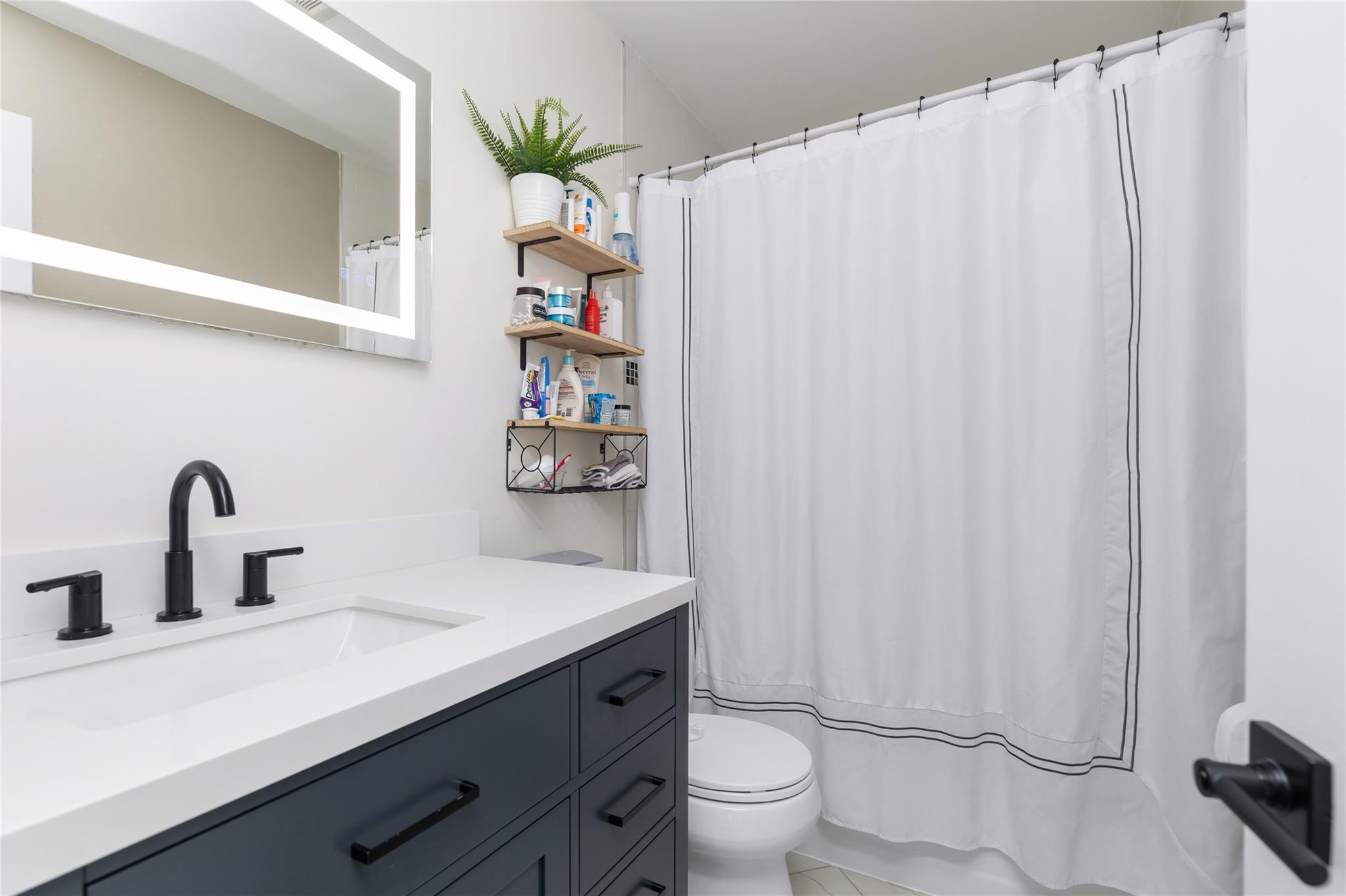 3461 Southwest 24th Street Miami, FL 33145 - Photo 25 of 55 a bathroom with a sink toilet and shower