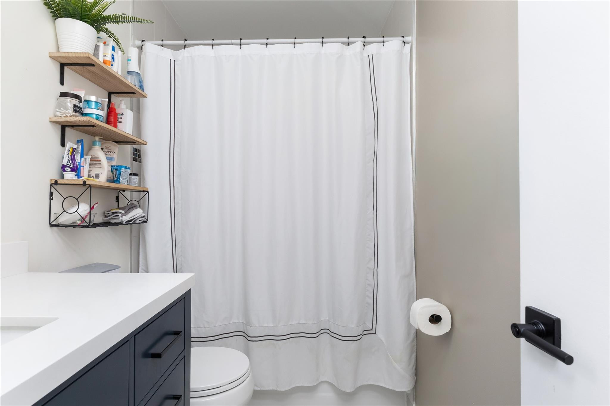 3461 Southwest 24th Street Miami, FL 33145 - Photo 26 of 55 a bathroom with a sink a toilet and a shower curtain