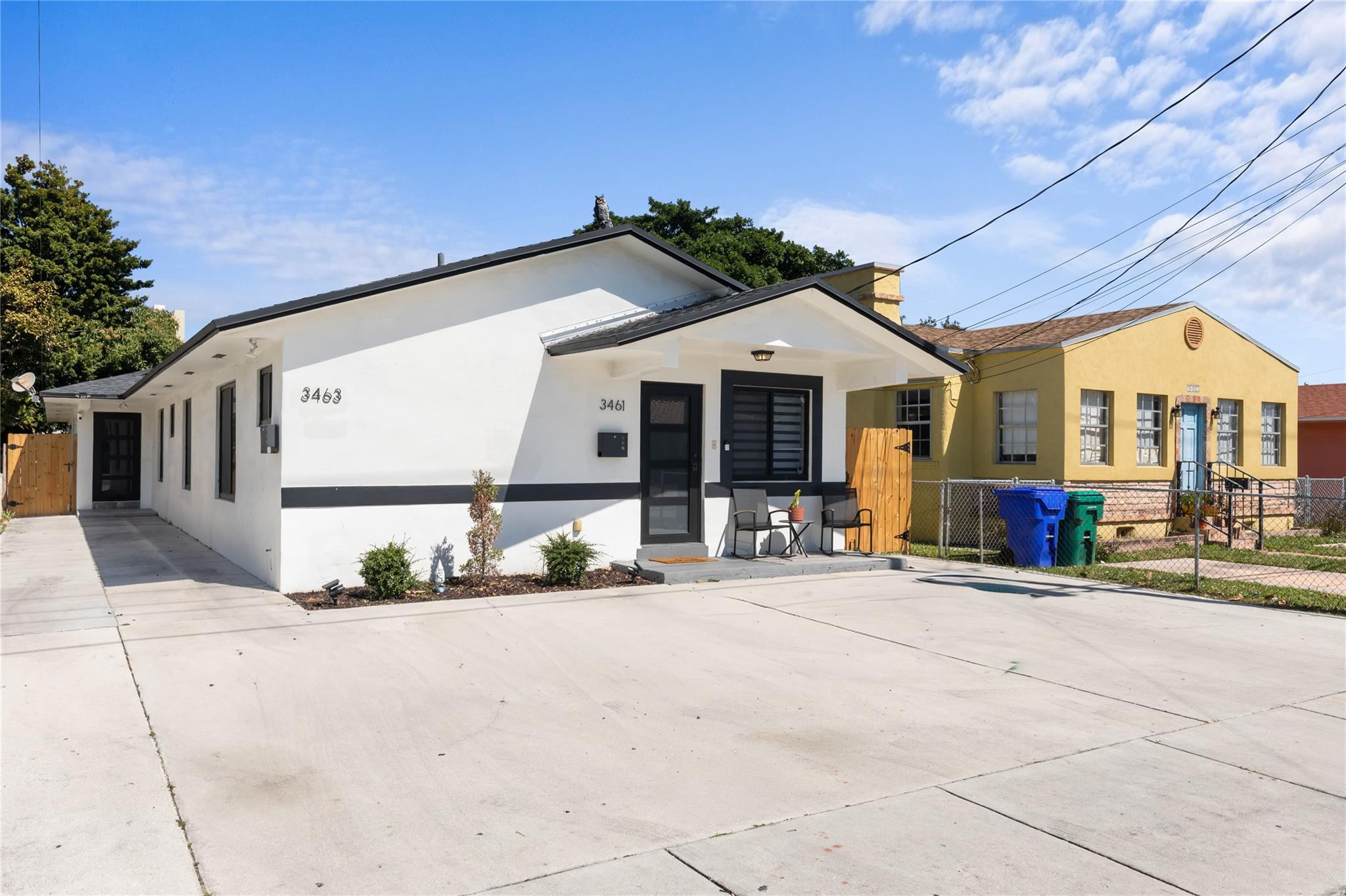 3461 Southwest 24th Street Miami, FL 33145 - Photo 3 of 55 a front view of a building with large trees and entryway