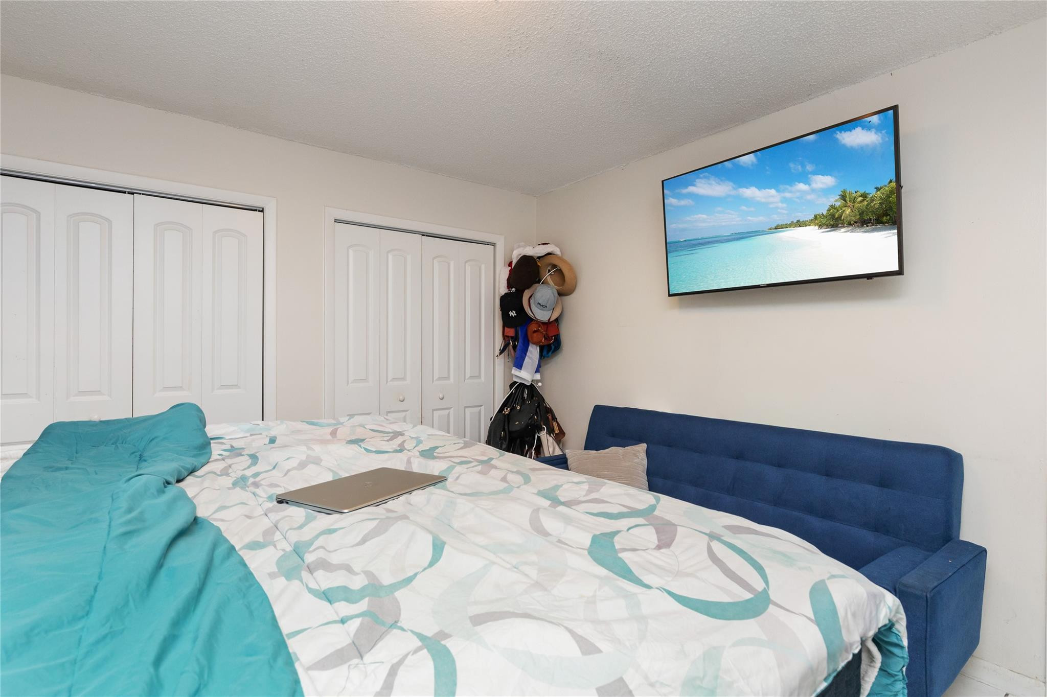 3461 Southwest 24th Street Miami, FL 33145 - Photo 49 of 55 a bed sitting in a bedroom and painting on the wall