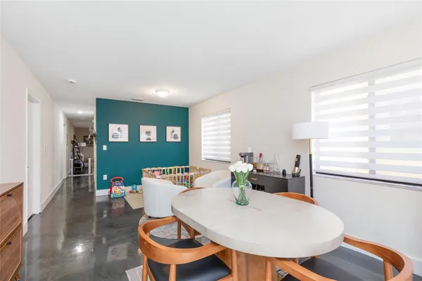 a view of a dining room with furniture and a mirror