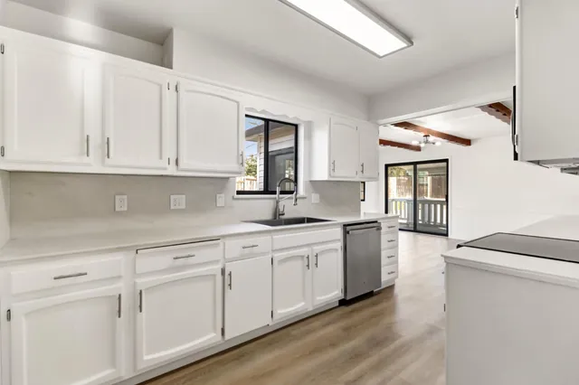 a kitchen with sink cabinets and window