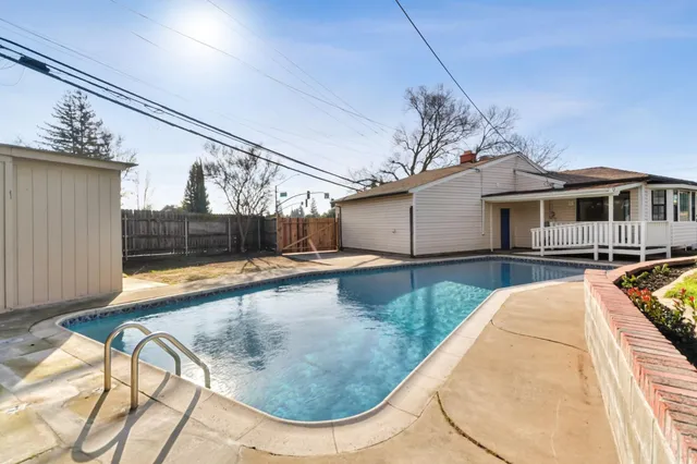 a view of a swimming pool with a patio