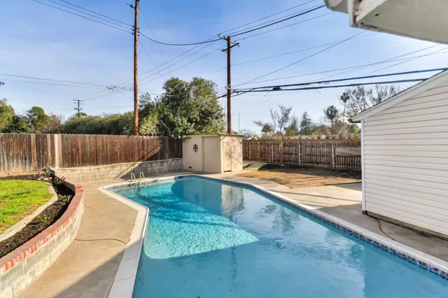 a view of a swimming pool with a patio