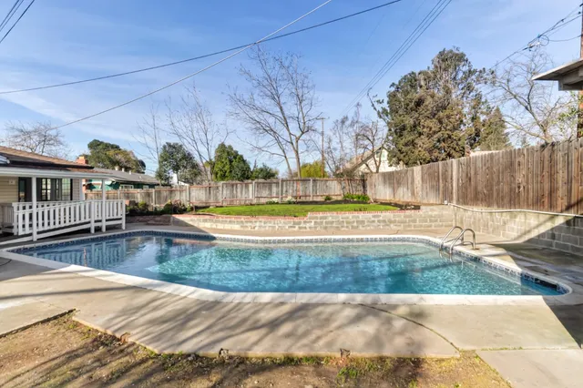 a view of swimming pool with a yard