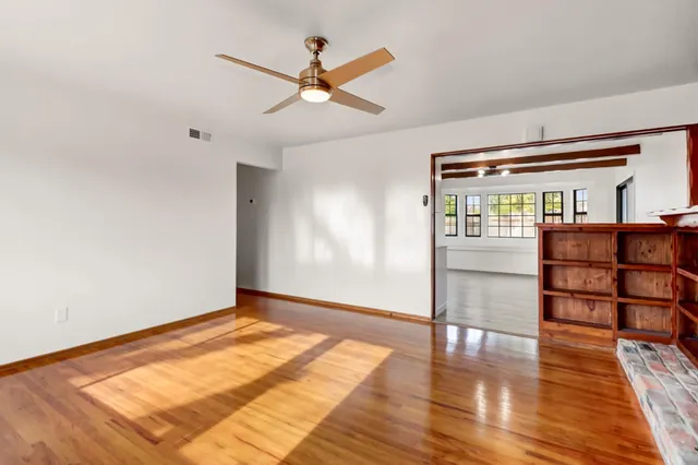 wooden floor in an empty room with a window